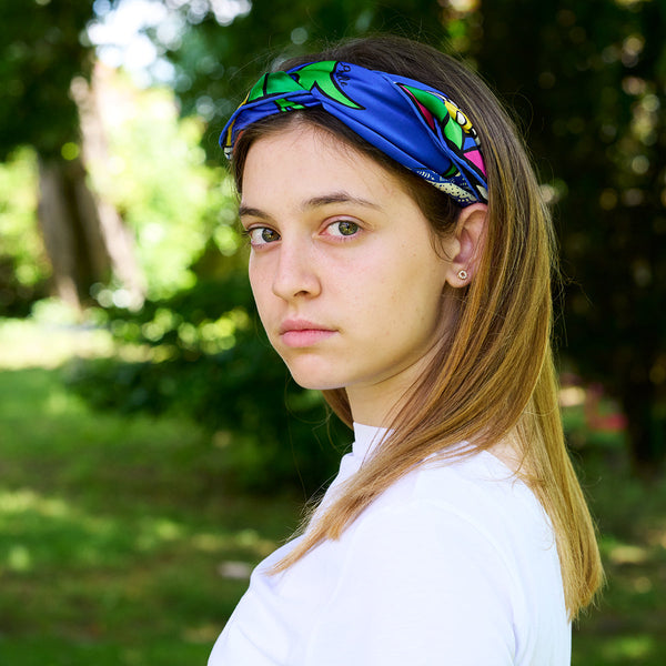 Teenager wearing as a headscarf the marine Rossignol silk scarf designed by Niki de Saint Phalle in the early 80's. Italian silk.